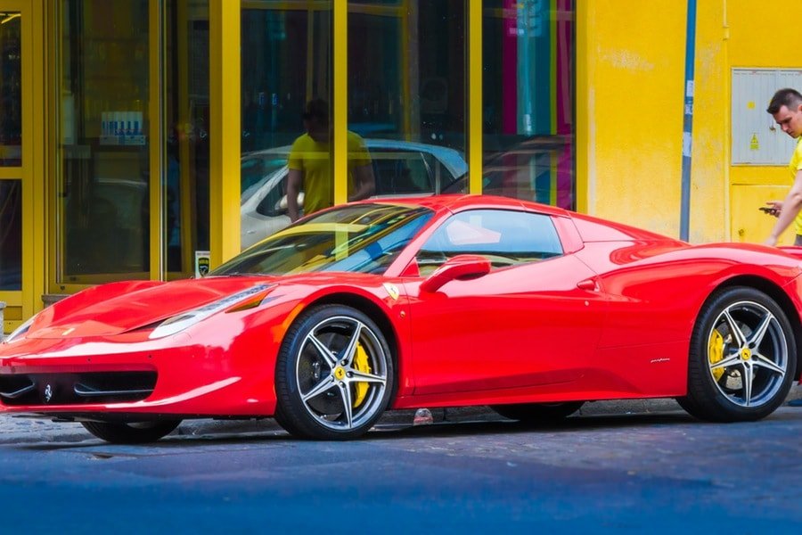 Red ferrari supercar in ways